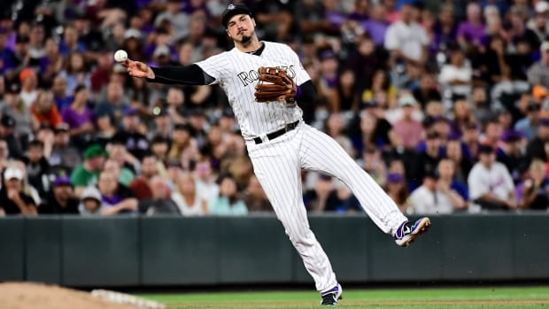 Sep 16, 2019; Denver, CO, USA; Colorado Rockies third baseman Nolan Arenado (28) throws the ball against the New York Mets in the eighth inning at Coors Field. Mandatory Credit: Ron Chenoy-USA TODAY Sports